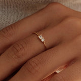 Close-up of two hands with a ring on a neutral background